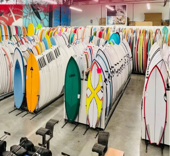 Rows of surfboards stored in the factory warehouse