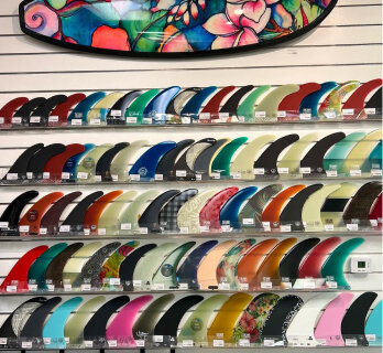 Surfboard fins displayed on a retail wall