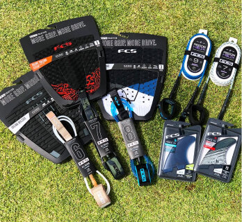 Surf accessories including traction pads and leashes